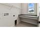Functional laundry room with granite countertop and window at 5283 Everlong Dr, Apollo Beach, FL 33572