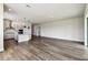 Open-concept living space featuring wood-look floors and a modern kitchen with stainless steel appliances at 5283 Everlong Dr, Apollo Beach, FL 33572