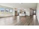 Open-concept living space showcasing the modern kitchen, hard wood floors, and an abundance of natural light at 5283 Everlong Dr, Apollo Beach, FL 33572