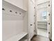 Bright mudroom featuring a built-in bench, coat hooks, and access to a laundry room at 5283 Everlong Dr, Apollo Beach, FL 33572