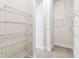 Bright walk-in closet with white wire shelving and neutral carpet at 5283 Everlong Dr, Apollo Beach, FL 33572