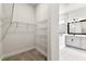Walk-in closet with wire shelving next to a modern bathroom at 5283 Everlong Dr, Apollo Beach, FL 33572