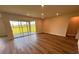Living room featuring plank floors, neutral paint, recessed lighting, and sliding doors to the backyard at 4319 Pullet Ct, Bradenton, FL 34211
