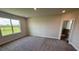 Spacious main bedroom with carpet, large window with a field view, and ensuite bathroom at 4319 Pullet Ct, Bradenton, FL 34211