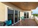 Comfortable outdoor balcony with seating, ceramic tile flooring, and glass sliding doors, perfect for enjoying the weather at 12077 Gandy N Blvd # 344, St Petersburg, FL 33702