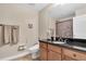 Bathroom with granite vanity, large mirror, towels and tile floor at 12077 Gandy N Blvd # 344, St Petersburg, FL 33702