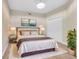 Comfortable bedroom featuring plush carpet, a decorative chandelier, and neutral paint at 12077 Gandy N Blvd # 344, St Petersburg, FL 33702