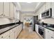 Bright kitchen with white cabinets, stainless steel appliances and granite countertops at 12077 Gandy N Blvd # 344, St Petersburg, FL 33702