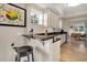 Bright kitchen featuring stone countertops, white cabinets, and a view to the adjacent dining space at 12077 Gandy N Blvd # 344, St Petersburg, FL 33702