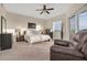 Spacious main bedroom featuring plush carpet, ceiling fan and a large window for natural light at 12077 Gandy N Blvd # 344, St Petersburg, FL 33702