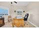Home office showcasing a wooden executive desk, leather chair, and serene window view at 12077 Gandy N Blvd # 344, St Petersburg, FL 33702