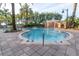 Community pool surrounded by lush landscaping and tiled walkways at 12077 Gandy N Blvd # 344, St Petersburg, FL 33702