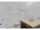 Bright bathroom featuring a shower-tub combo with tile surround, a vanity with sink, and a large mirror at 17108 Carrington Park Dr # 710, Tampa, FL 33647