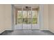 Sliding doors open to an outdoor patio with a ceiling fan and views of the surrounding nature at 17108 Carrington Park Dr # 710, Tampa, FL 33647