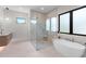 Contemporary bathroom with a glass shower, soaking tub, and modern fixtures at 2517 N Riverside Dr, Tampa, FL 33602