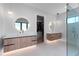 Luxurious bathroom with double vanities, unique lighting, and glass-enclosed shower at 2517 N Riverside Dr, Tampa, FL 33602