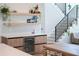 Modern dining area featuring a wine cooler and dry bar, adjacent to staircase at 2517 N Riverside Dr, Tampa, FL 33602