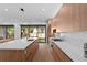 Modern kitchen featuring wood cabinetry, a large island, and sliding glass doors to the backyard at 2517 N Riverside Dr, Tampa, FL 33602