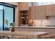 Modern kitchen with light wood cabinets, stainless steel appliances, and a stylish backsplash at 2517 N Riverside Dr, Tampa, FL 33602