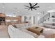 Open-concept living room with modern decor, spacious seating, and staircase with metal railings at 2517 N Riverside Dr, Tampa, FL 33602
