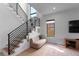 Bright living room showcasing the modern staircase and natural light from two windows at 2517 N Riverside Dr, Tampa, FL 33602
