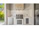 Outdoor kitchen featuring a built-in grill, stainless steel appliances, and stone countertops at 2517 N Riverside Dr, Tampa, FL 33602