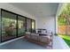 Covered patio with sliding glass doors, comfortable seating, and outdoor space at 2517 N Riverside Dr, Tampa, FL 33602
