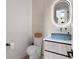 Stylish powder room featuring a unique blue vessel sink and modern lighting at 2517 N Riverside Dr, Tampa, FL 33602