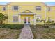 Charming entryway with double doors and a brick path, set in a building with vibrant yellow siding at 3889 Pompano Se Dr # A, St Petersburg, FL 33705