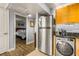 The kitchen includes a washer and dryer, and is adjacent to the bedroom at 3889 Pompano Se Dr # A, St Petersburg, FL 33705