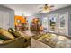Bright, open living room with wood-look floors, leading to a dining area and outdoor patio at 3889 Pompano Se Dr # A, St Petersburg, FL 33705