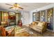 Cozy living room featuring wood floors, ornate screens, and ample seating with decorative pillows at 3889 Pompano Se Dr # A, St Petersburg, FL 33705
