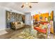 Comfortable living room showcasing stylish decor, wood floors, and an open layout to the dining area at 3889 Pompano Se Dr # A, St Petersburg, FL 33705