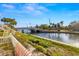 Beautiful canal view featuring a bridge, palm trees, and clear blue skies, adding to the scenic charm of the property at 3889 Pompano Se Dr # A, St Petersburg, FL 33705