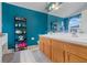 Bright bathroom features double sinks, wooden cabinets, shelving, and a large mirror at 4605 Lisette Cir, Brooksville, FL 34604