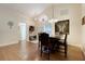 Inviting dining area with wood floors, a decorative light fixture, and a view of the front entrance at 4605 Lisette Cir, Brooksville, FL 34604