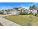 Well-maintained single-Gathering home featuring a neatly kept lawn and a paved driveway leading to a garage at 4605 Lisette Cir, Brooksville, FL 34604