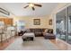 Comfortable living room with wood floors, a plush sectional sofa, and sliding glass doors to the outdoor area at 4605 Lisette Cir, Brooksville, FL 34604