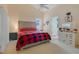 Comfortable main bedroom featuring a cozy bed, soft lighting, and a vanity area, offering a relaxing retreat at 4605 Lisette Cir, Brooksville, FL 34604