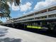 A view of the condo complex with covered parking and several cars at 4920 Locust Ne St # 116, St Petersburg, FL 33703