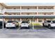 Parking lot shot of the condo complex showing covered parking spaces at 4920 Locust Ne St # 116, St Petersburg, FL 33703