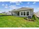 An inviting backyard with a green lawn and a covered patio at 5289 Everlong Dr, Apollo Beach, FL 33572