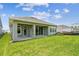 Back of the home with a covered patio and a large yard space at 5289 Everlong Dr, Apollo Beach, FL 33572