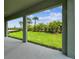 A covered patio looking out to a green lawn and lush landscaping at 5289 Everlong Dr, Apollo Beach, FL 33572