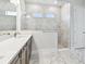 Spa-like bathroom with marble tile shower and countertops, plus natural light at 5289 Everlong Dr, Apollo Beach, FL 33572