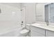 Bathroom featuring a white tiled tub-shower combo, toilet and modern sink at 5289 Everlong Dr, Apollo Beach, FL 33572