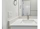 Bathroom with a white basin sink, mirror, and white cabinets at 5289 Everlong Dr, Apollo Beach, FL 33572