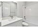 A bathroom featuring white cabinets, a white basin sink, and a tub with white tile at 5289 Everlong Dr, Apollo Beach, FL 33572