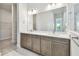 Elegant bathroom featuring a double vanity, modern fixtures, and marble floors at 5289 Everlong Dr, Apollo Beach, FL 33572
