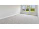 Bedroom with soft gray carpet and three bright windows at 5289 Everlong Dr, Apollo Beach, FL 33572